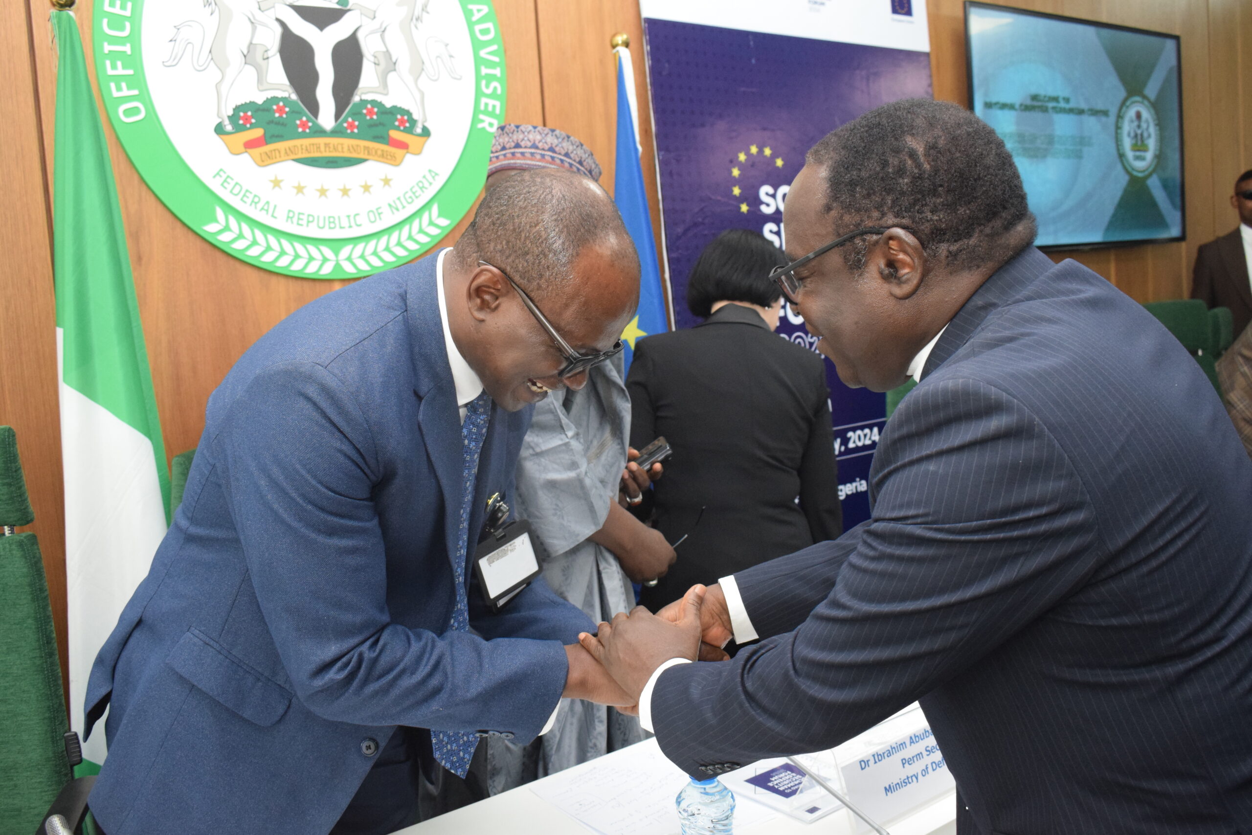 National Coordinator, NCTC, Maj. Gen. AG Laka in a handshake with Bishop Matthew Hassan Kukah of Catholic Diocese of Sokoto at the event